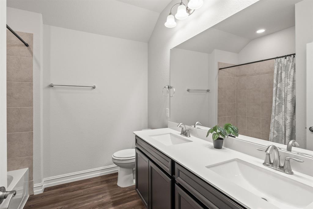 2920 Arlo Road Aubrey, TX 76227 - Photo 16 of 31 a bathroom with a sink a toilet and shower