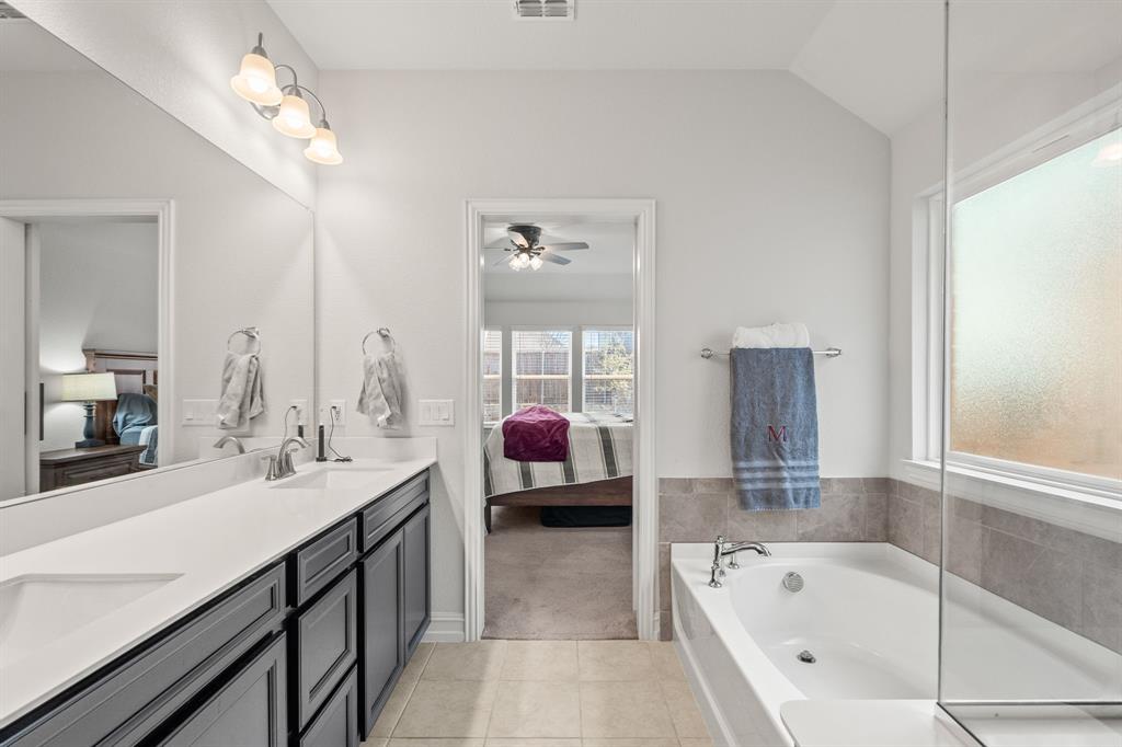 2920 Arlo Road Aubrey, TX 76227 - Photo 21 of 31 a en suite spacious bathroom with a tub sink and mirror
