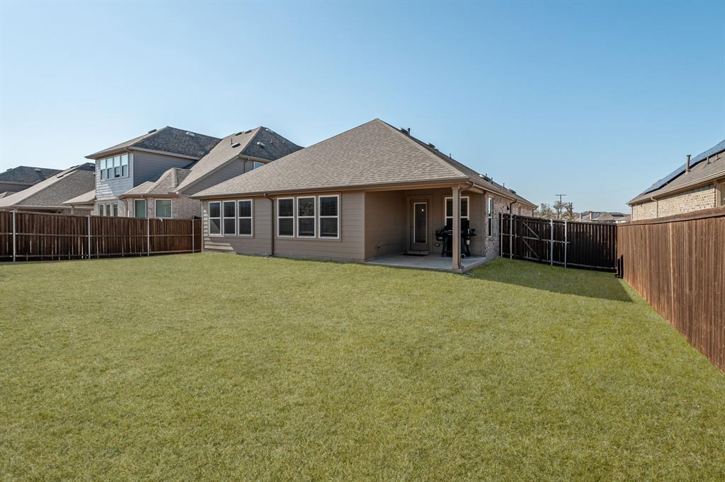 2920 Arlo Road Aubrey, TX 76227 - Photo 25 of 31 a view of a house with a yard and sitting area