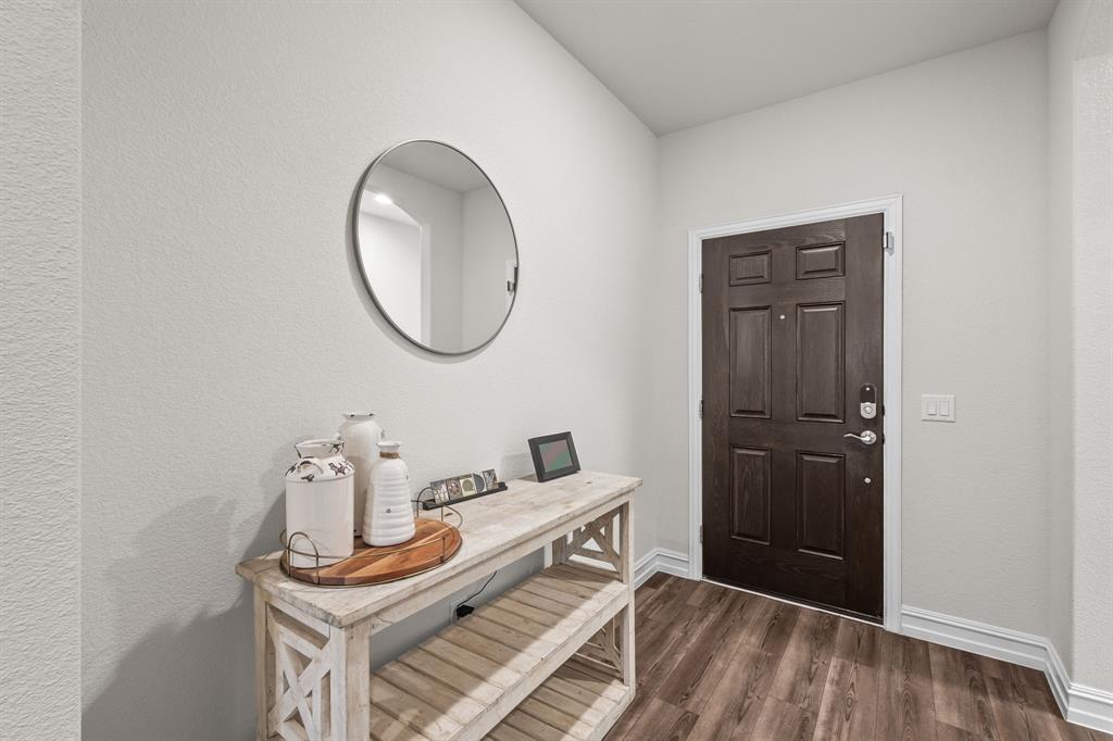 2920 Arlo Road Aubrey, TX 76227 - Photo 3 of 31 a room with a table and a mirror