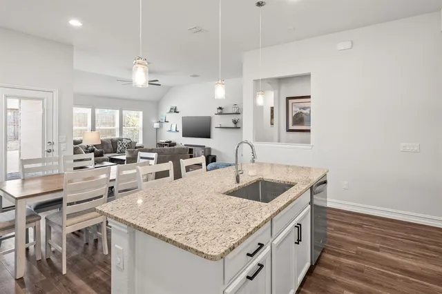 a kitchen with a stove a sink and a refrigerator