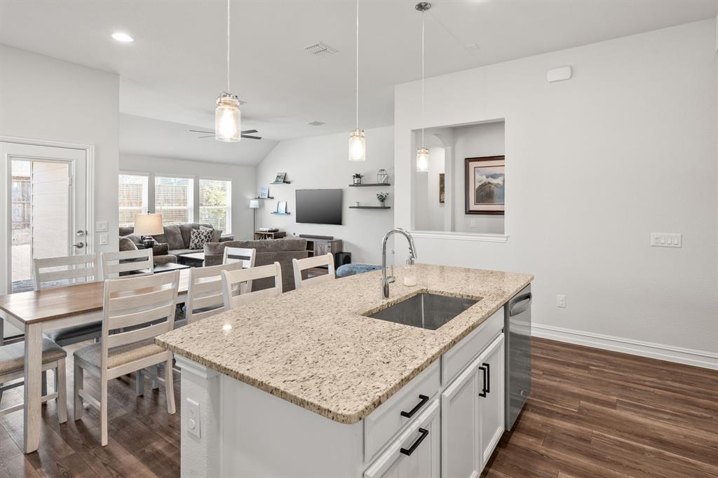 2920 Arlo Road Aubrey, TX 76227 - Photo 6 of 31 a kitchen with a stove a sink and a refrigerator