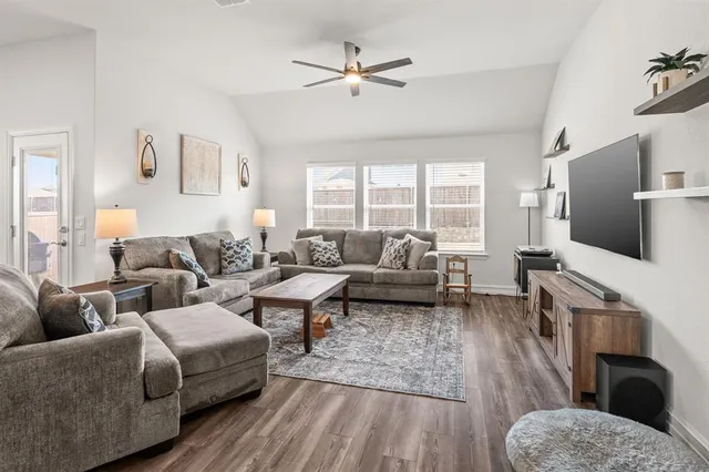 a living room with furniture and a flat screen tv