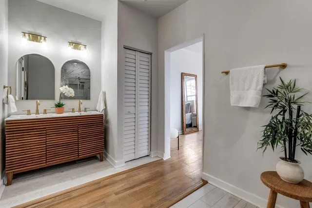 a living room with a couch and a potted plant