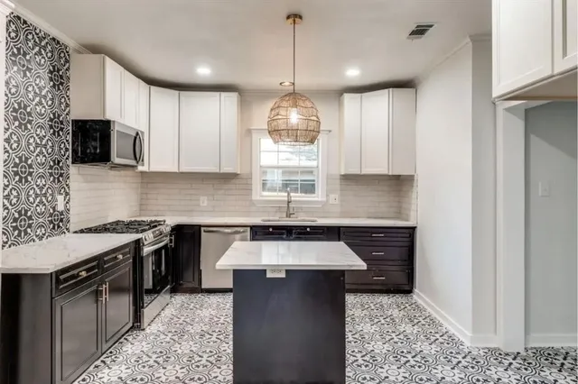 a kitchen with a sink a stove and microwave