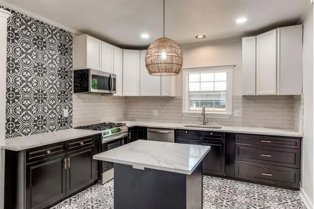a kitchen with a sink stove and cabinets