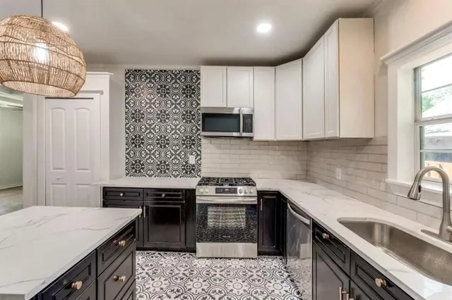 a kitchen with a sink a stove and oven