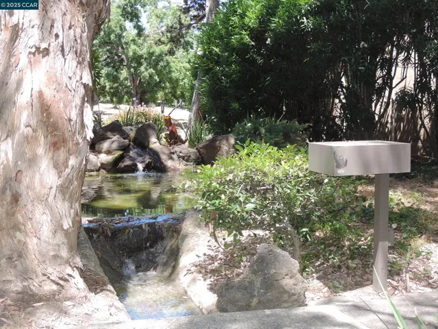 a view of a small space with wooden floor and a window