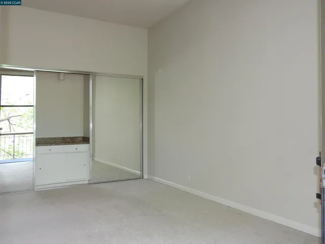 a kitchen with granite countertop white cabinets and sink