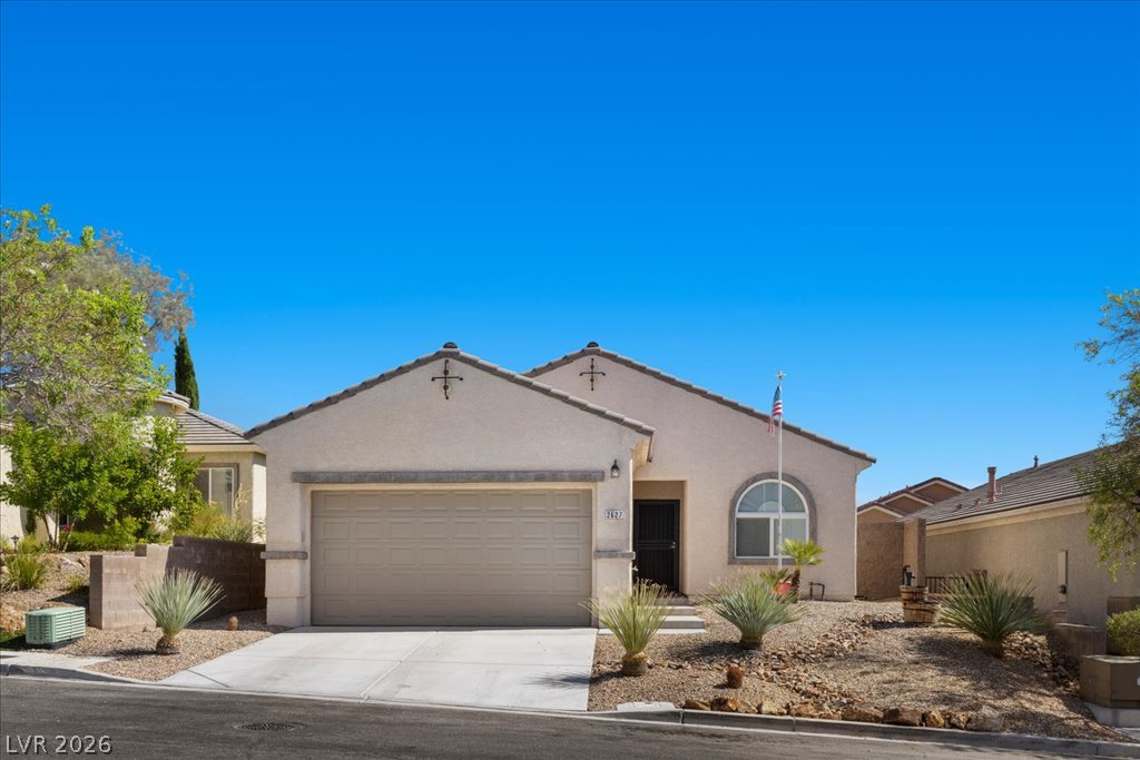 2627 Dirleton Place Henderson, NV 89044 - Photo 34 of 42 A well-maintained stucco home with an attached garage and desert-friendly landscaping.