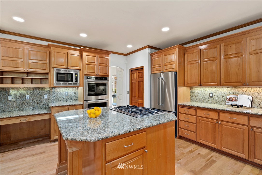 4729 176th Street Southeast Bothell, WA 98012 - Photo 12 of 40 a kitchen with stainless steel appliances granite countertop sink stove refrigerator and cabinets