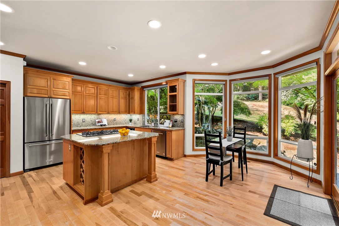 4729 176th Street Southeast Bothell, WA 98012 - Photo 13 of 40 a kitchen with stainless steel appliances granite countertop sink stove top oven and cabinets
