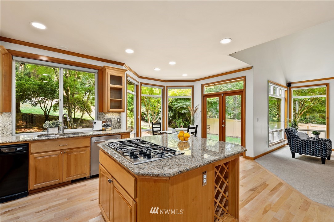 4729 176th Street Southeast Bothell, WA 98012 - Photo 24 of 40 a kitchen with kitchen island granite countertop a stove and a sink