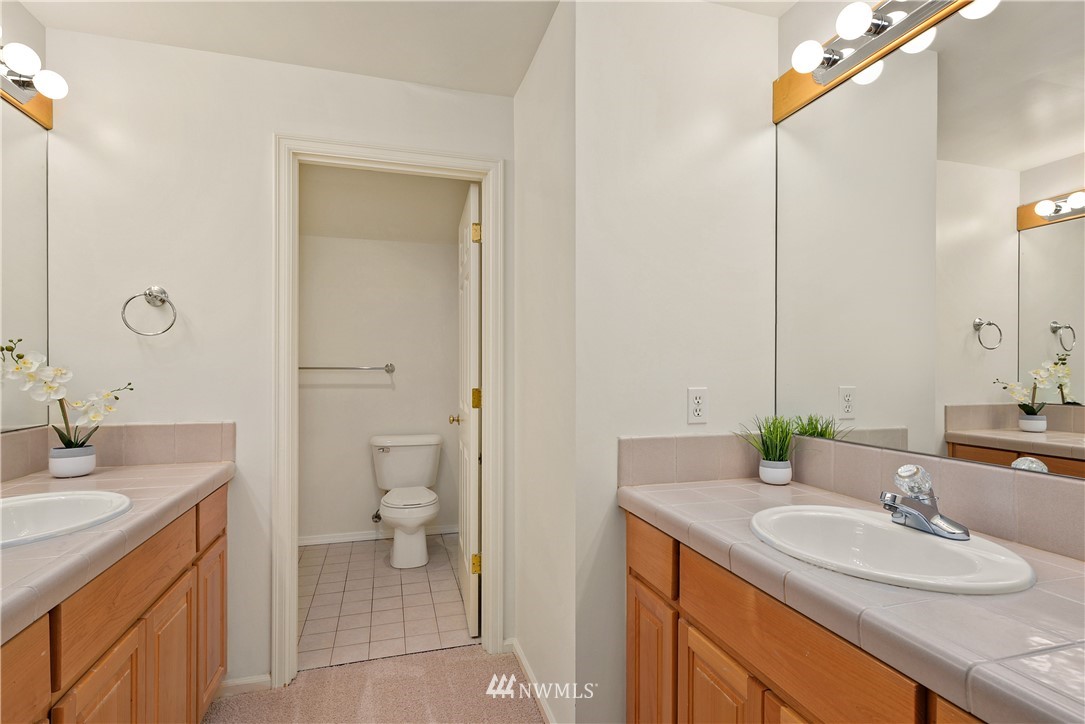 4729 176th Street Southeast Bothell, WA 98012 - Photo 34 of 40 a bathroom with a granite countertop sink toilet and shower