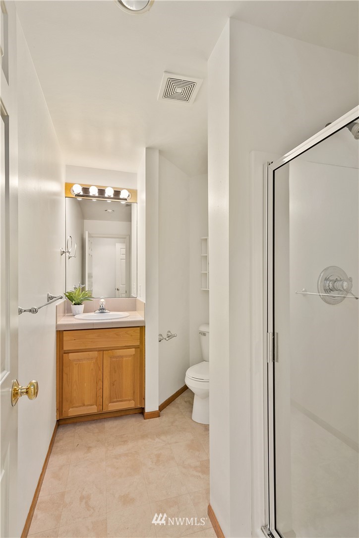 4729 176th Street Southeast Bothell, WA 98012 - Photo 35 of 40 a bathroom with a granite countertop sink mirror and toilet