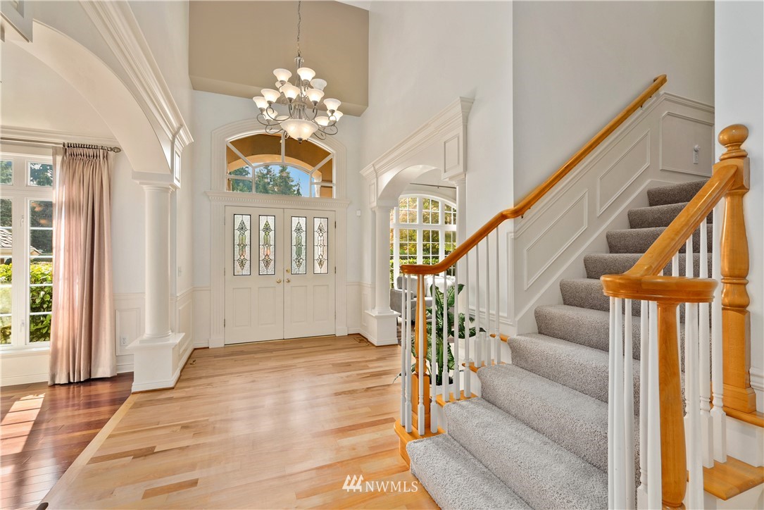 4729 176th Street Southeast Bothell, WA 98012 - Photo 7 of 40 a view of an entryway with wooden floor and a chandelier