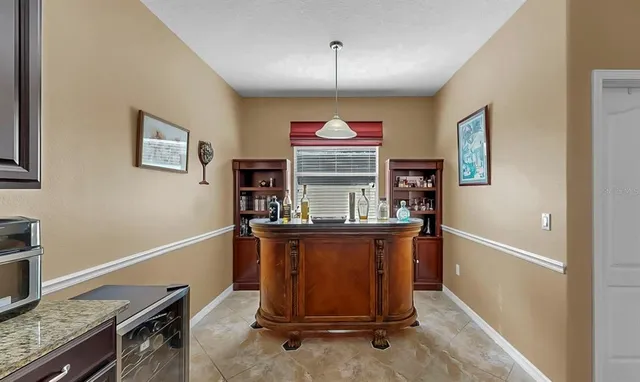 a living room with furniture a fireplace and a large window