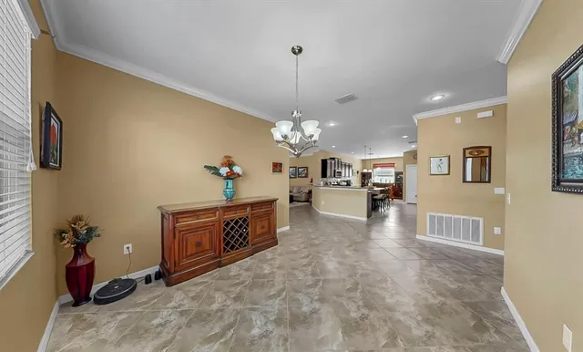 a living room with furniture and kitchen view