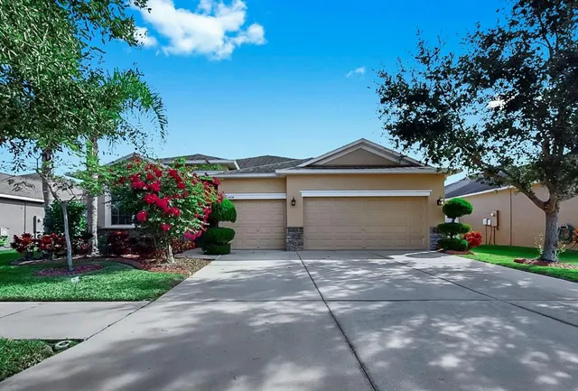 a front view of a house with a yard and a garage