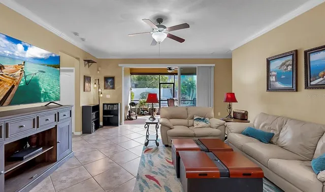a bedroom with a bed and a ceiling fan