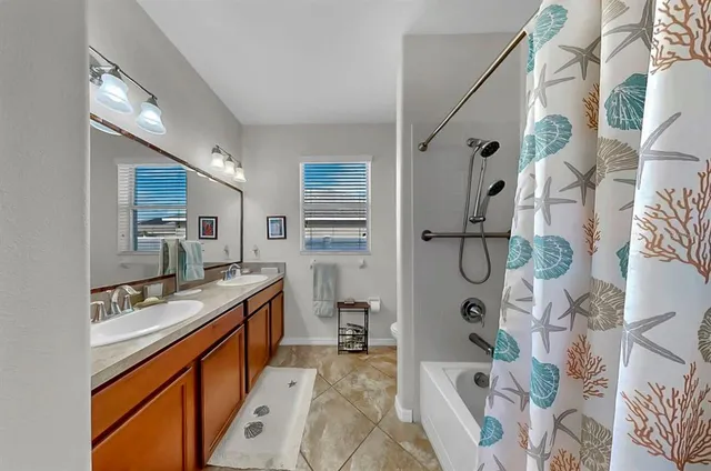 a front view of a house with a yard and garden