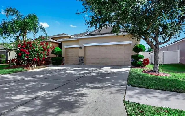 a view of a kitchen with kitchen island stainless steel appliances refrigerator stove microwave and cabinets