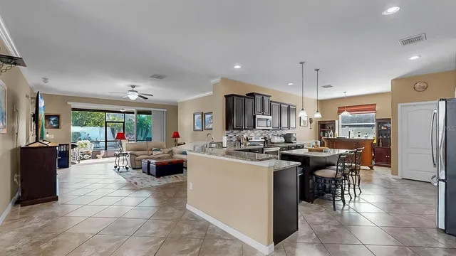 a kitchen with refrigerator and cabinets