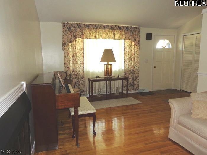 36490 Aurensen Road North Ridgeville, OH 44039 - Photo 5 of 24 Formal living room with woodburner fireplace and hardwood flooring