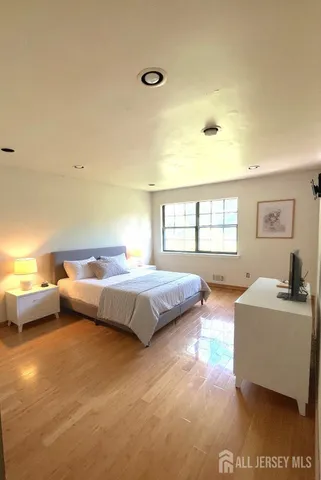 a bedroom with a bed couch and a window