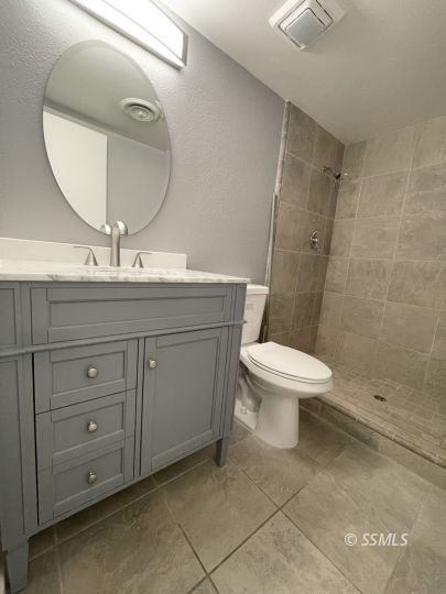 656 West Felspar Avenue Ridgecrest, CA 93555 - Photo 24 of 45 a bathroom with a toilet a sink and mirror