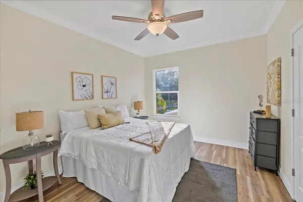 a bedroom with a bed and wooden floor