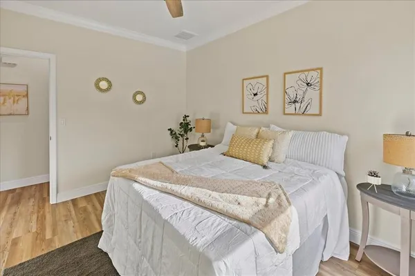 a bedroom with a bed and painting on the wall