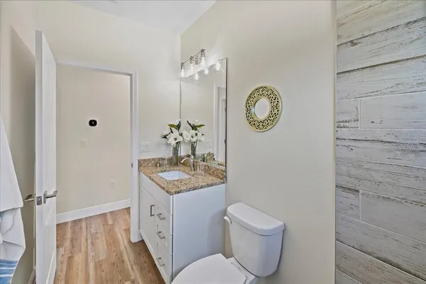 a spacious bathroom with a toilet a sink and a mirror
