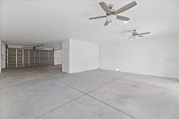 a view of a livingroom with a ceiling fan and window
