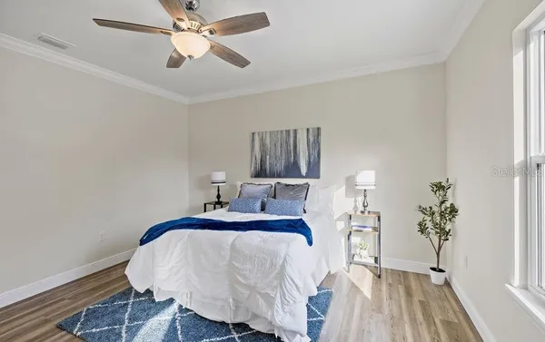 a bedroom with a bed and a chandelier