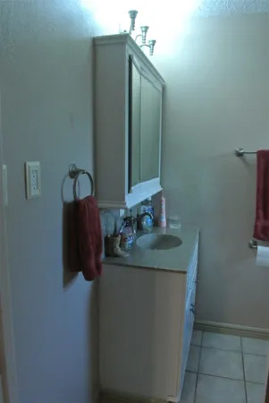 a white toilet sitting next to a window in a bathroom