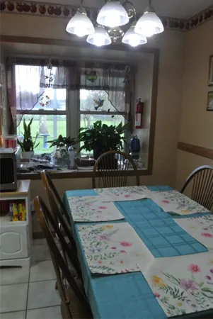 a kitchen with a table chairs and a dining table