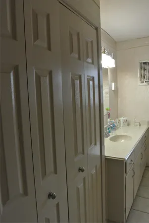 a bathroom with double vanity and a mirror