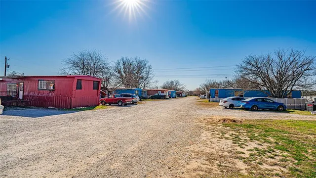 a front view of a building with cars parked