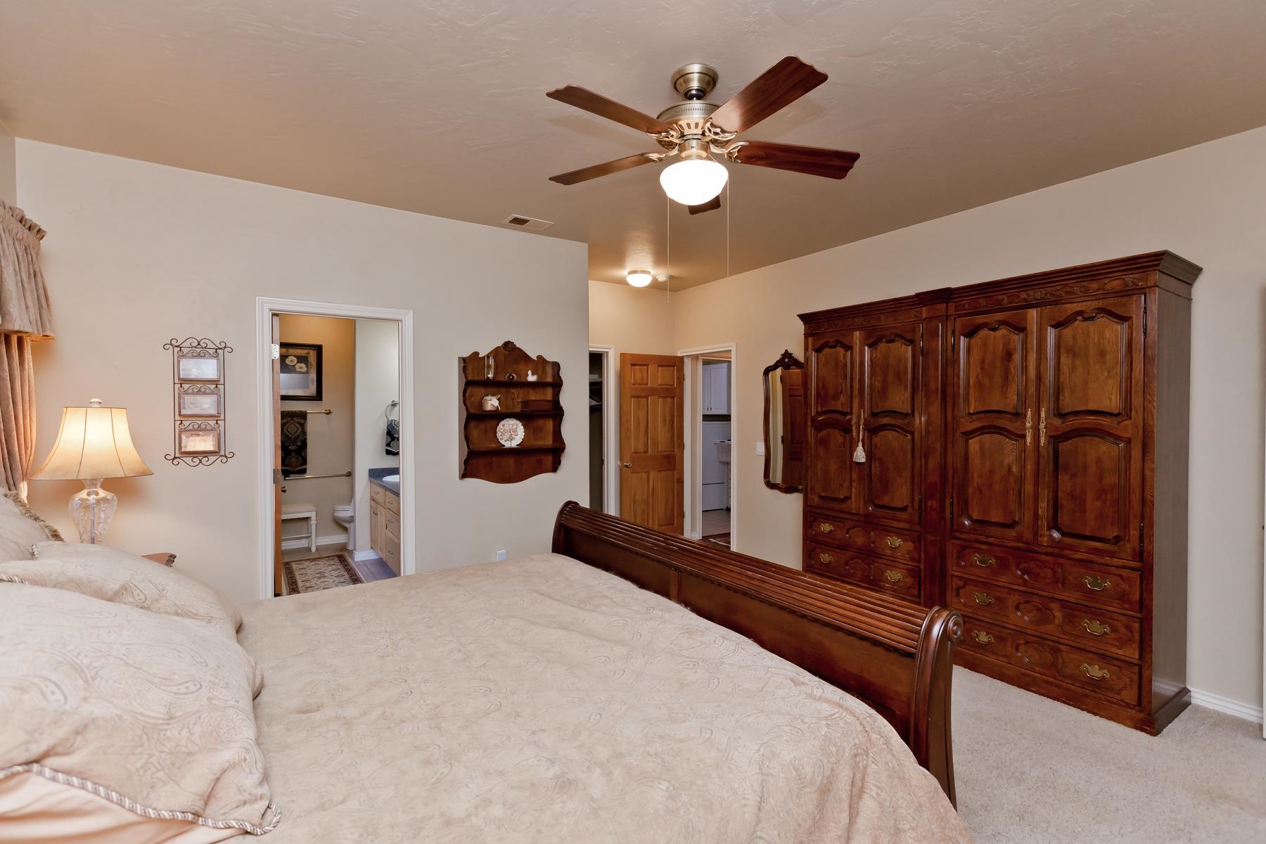 2912 El Torro Road Grand Junction, CO 81503 - Photo 15 of 34 a bedroom with a bed and a chandelier