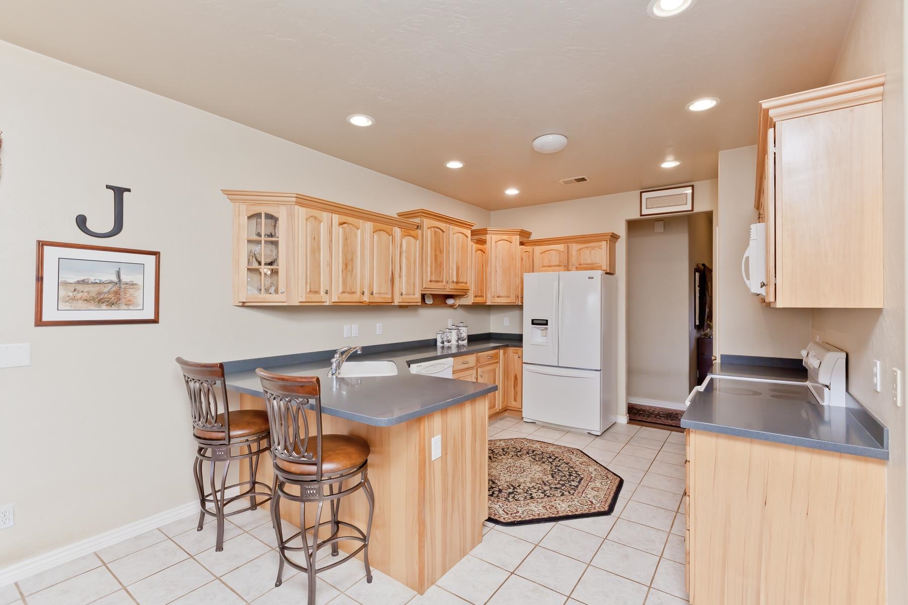 2912 El Torro Road Grand Junction, CO 81503 - Photo 10 of 34 a kitchen with a refrigerator and a stove top oven