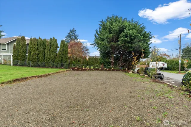 a view of a house with a yard and garage