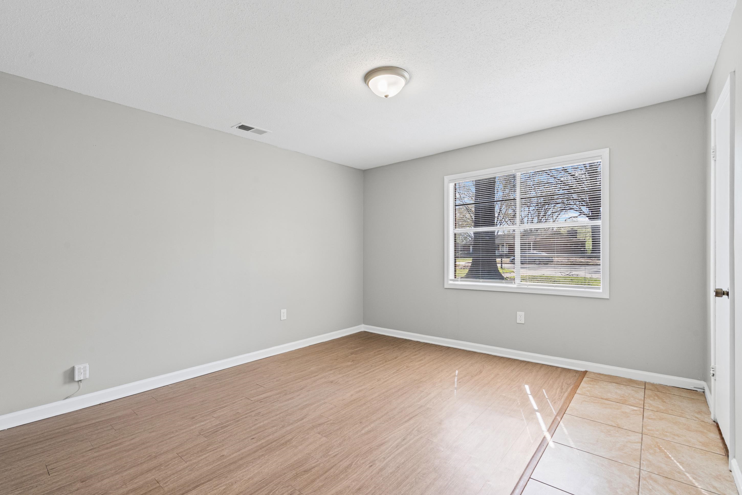496 Greenview Cove Collierville, TN 38017 - Photo 12 of 24 a view of an empty room with wooden floor and a window