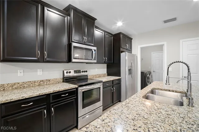 a view of a dining room with furniture a chandelier and window