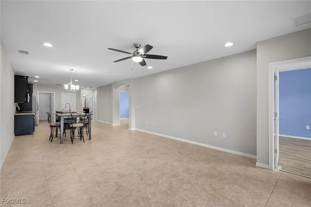 a view of a dining room with furniture and a chandelier