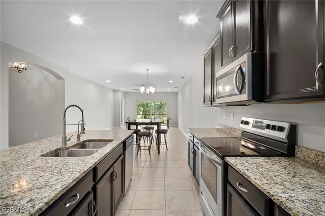 a kitchen with a stove a sink and a refrigerator