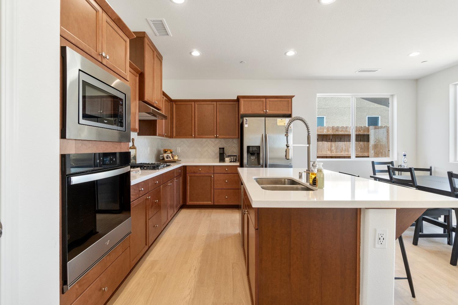 1241 Peters Road Madera, CA 93636 - Photo 12 of 37 a kitchen with stainless steel appliances granite countertop a sink stove and refrigerator