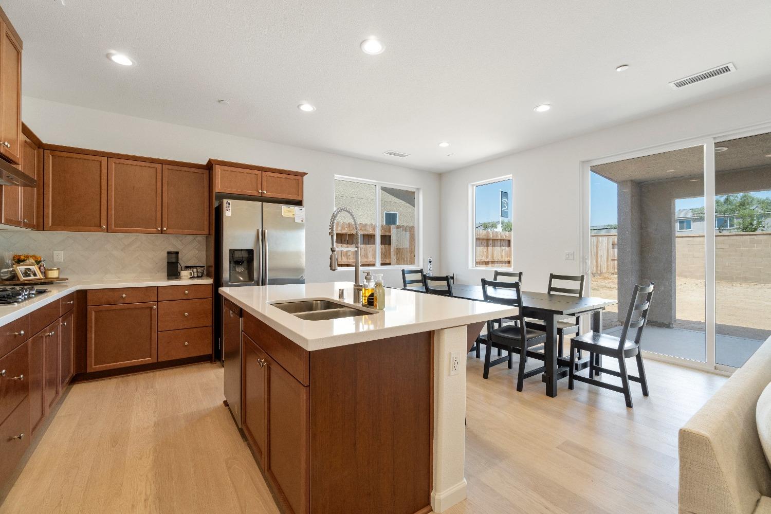 1241 Peters Road Madera, CA 93636 - Photo 2 of 37 a kitchen with a table chairs stove and cabinets