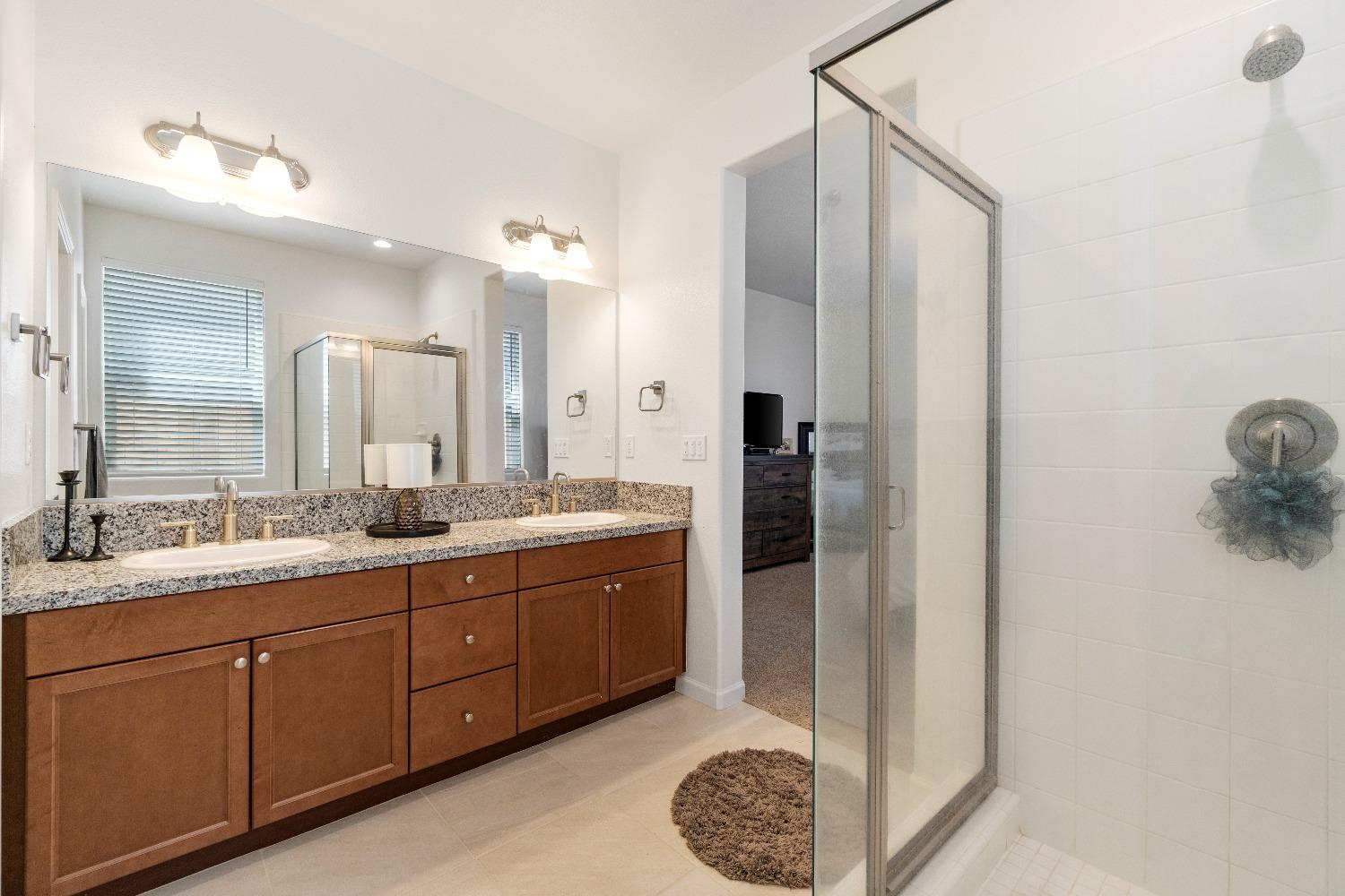 1241 Peters Road Madera, CA 93636 - Photo 29 of 37 a spacious bathroom with a double vanity sink a mirror and shower