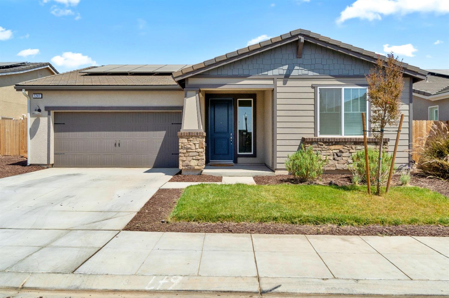 1241 Peters Road Madera, CA 93636 - Photo 4 of 37 a front view of a house with a garden